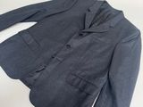 the jacket is blue and has buttons on the front