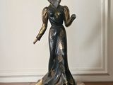 a statue of a woman standing on a marble base