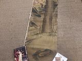 a painting on the floor next to a picture of a woman