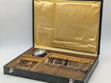a black case with silverware in it on a white surface