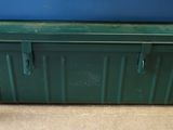 a green box sitting on the floor next to a blue box
