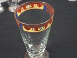 a glass with a design on it sitting on a table