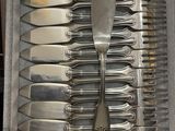 a lot of forks and spoons in a box