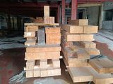several pieces of wood are stacked on top of each other in a warehouse