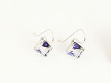 a pair of silver earrings with blue crystals on a white background