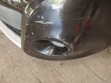 a close up of a car ' s front bumper with a hole in it