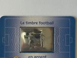 a badge with a picture of a football player on it