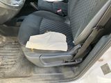 a picture of a car seat with a paper bag in it