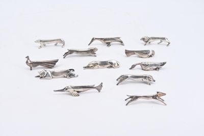 a lot of silver animal figurines on a white surface