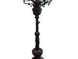 a tall metal candelab with a bunch of flowers on it