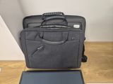 a laptop and a briefcase sitting on a table