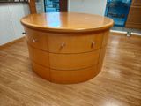 an image of a round wooden table in a room
