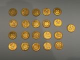 several gold coins are arranged in a circle on a white surface