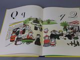 an open book with a picture of people and animals on it