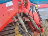an image of a blue and red tractor with a hose attached to the front of it
