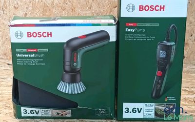two boxes of bosch blow dryers sitting on top of a wooden table