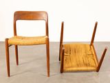 two wooden chairs sitting next to each other on a cement floor