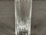 a shot glass sitting on a table with a black background