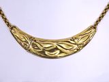an image of a gold necklace on a mannequin mannequin