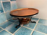 a metal tray on a stand on a tiled floor