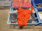 an orange shirt in a blue container on a pallet