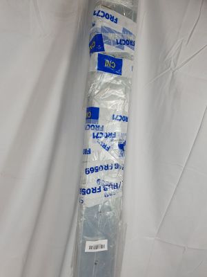 a tube of toothpaste wrapped in plastic on a white sheet