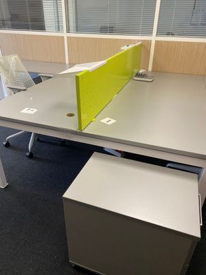a desk with a chair and a desk top with a yellow divider