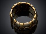 a close up of a gold ring on a black surface