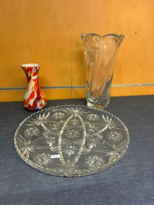 two vases and a plate sitting on a table