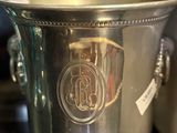 a silver ice bucket sitting on a table