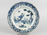 a blue and white plate with a picture of a man and a woman