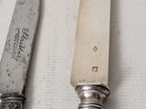 two knives that are sitting next to each other on a table