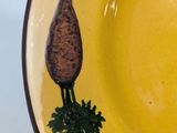 a yellow plate with a picture of a carrot on it