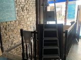 a staircase leading up to a bar with a blue umbrella