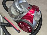 a vacuum that is sitting on the floor next to a canister