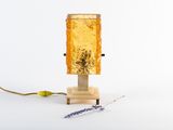 a small lamp that is sitting on a wooden stand