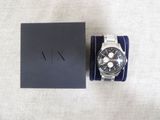 a close up of a watch with a box on a table