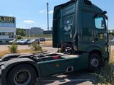 a green semi truck parked in a parking lot