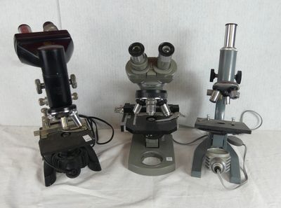 three microscopes that are sitting on a table