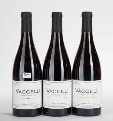 three bottles of wine are lined up on a white surface
