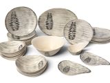 a lot of plates and bowls that are sitting on a table