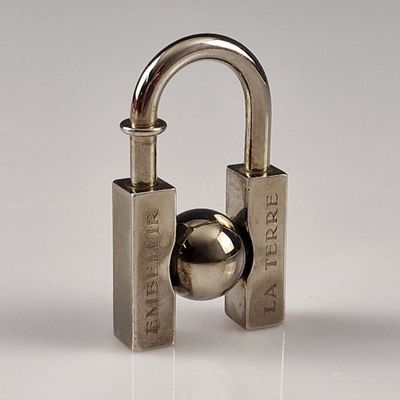 a metal padlock with a ball attached to it