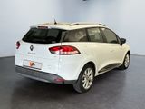 the rear end of a white car parked in a garage