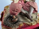 a doll that is sitting on top of a piece of cloth