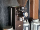 a coffee grinder sitting on top of a shelf next to other items