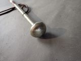 a silver trumpet that is laying on a table