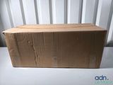 an open box sitting on top of a table next to a wall