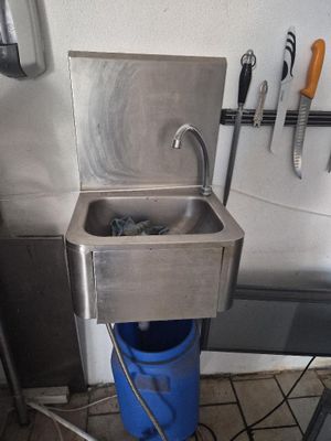 an image of a kitchen with a sink and a blue bucket