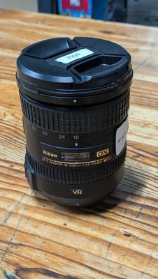 a close up of a camera lens on a wooden table