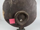 an image of a wooden object with a pink tag on top of it